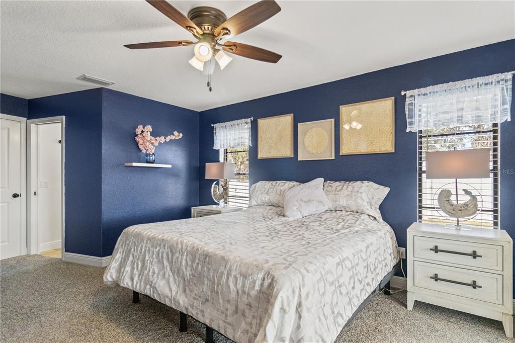 488 Fieldstone Lane Spring Hill, FL 34606 - Photo 26 of 55 a bedroom with a bed and a chandelier