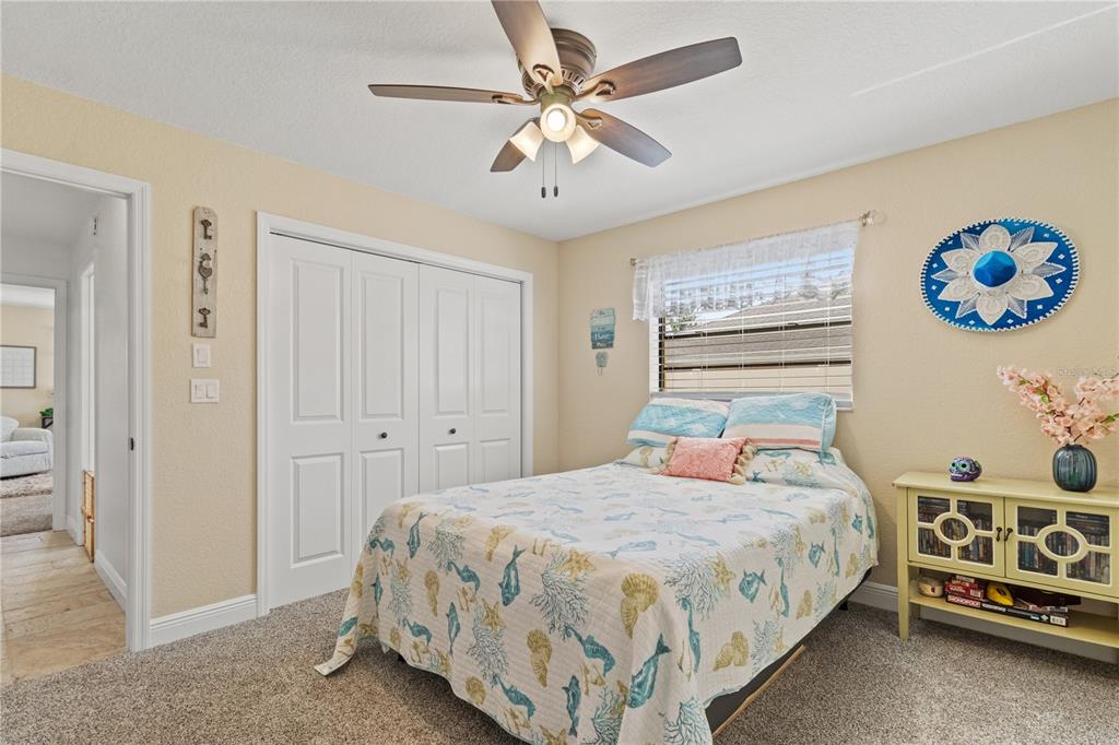 488 Fieldstone Lane Spring Hill, FL 34606 - Photo 30 of 55 a bedroom with a bed and a chandelier