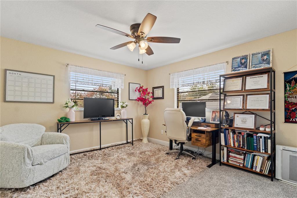 488 Fieldstone Lane Spring Hill, FL 34606 - Photo 33 of 55 a living room with furniture and a flat screen tv