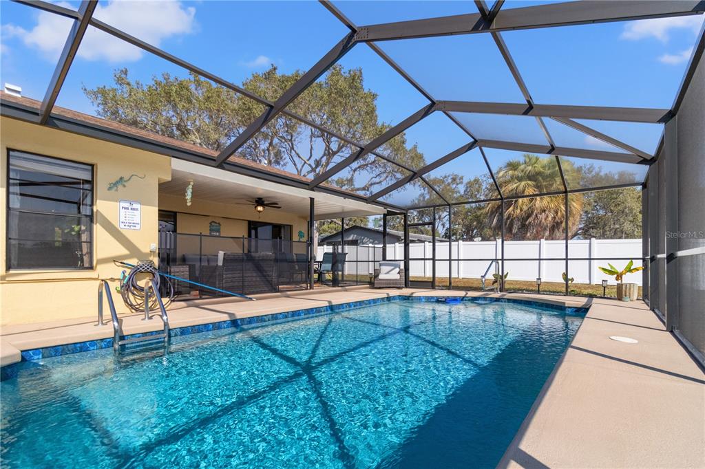 488 Fieldstone Lane Spring Hill, FL 34606 - Photo 38 of 55 a view of a swimming pool with a porch