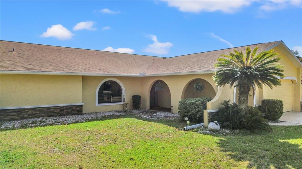 488 Fieldstone Lane Spring Hill, FL 34606 - Photo 52 of 55 a front view of a house with garden