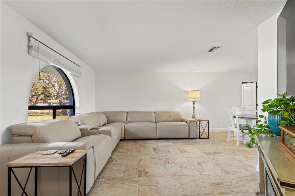 488 Fieldstone Lane Spring Hill, FL 34606 - Photo 8 of 55 a living room with furniture and a large window