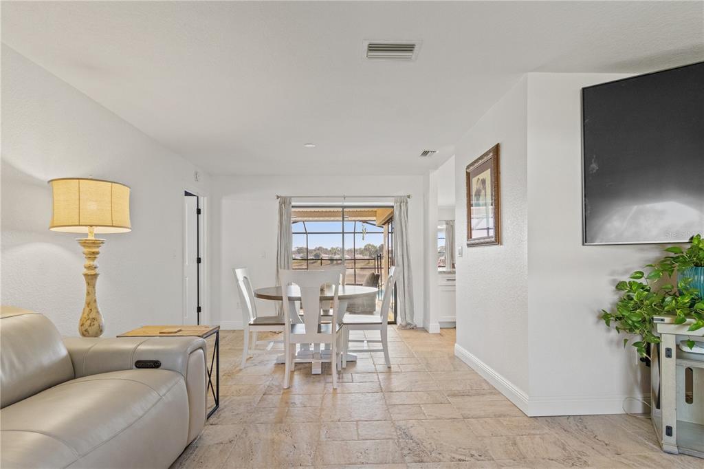 488 Fieldstone Lane Spring Hill, FL 34606 - Photo 10 of 55 a living room with furniture a potted plant and a lamp