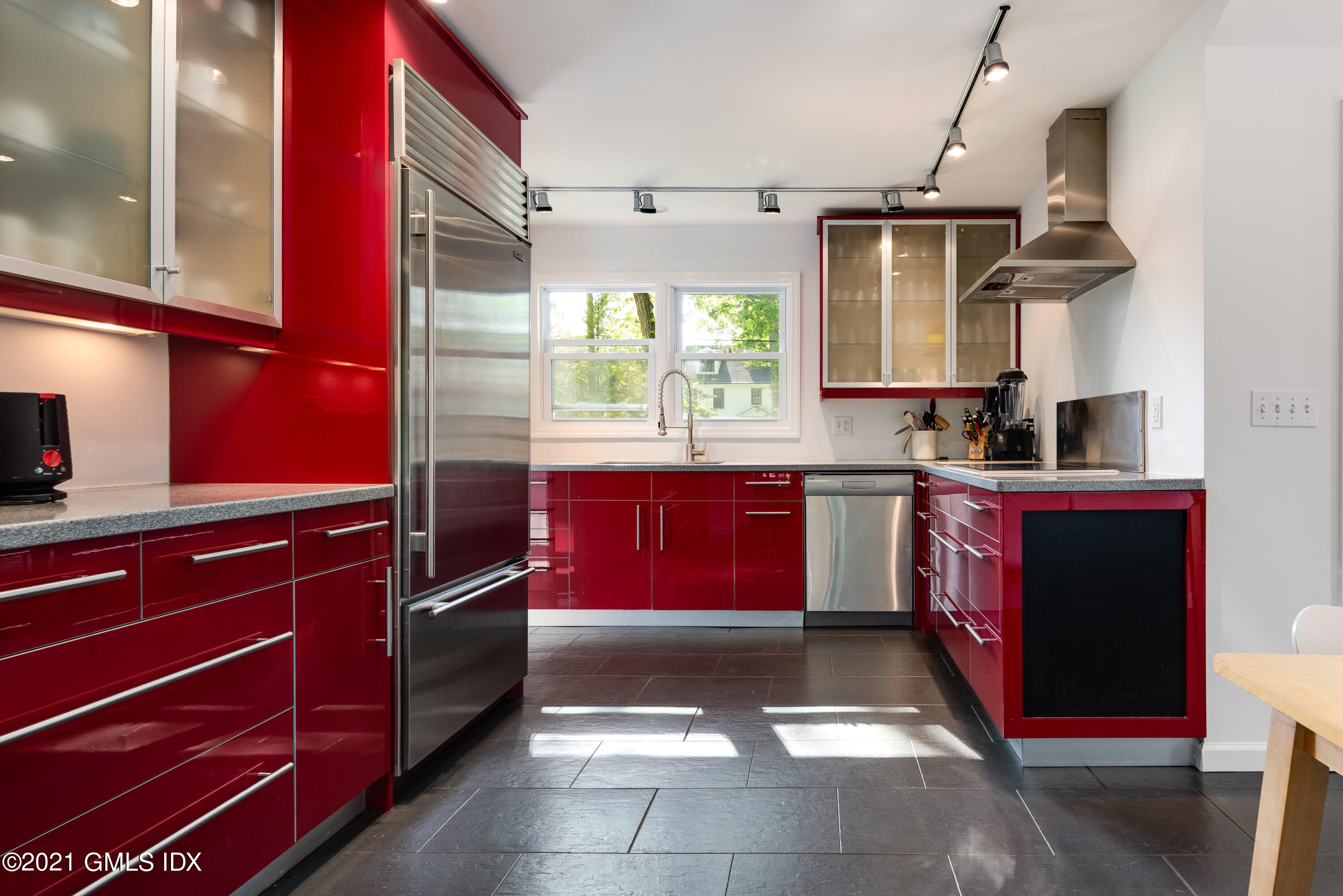 90 Oneida Drive Greenwich, CT 06830 - Photo 15 of 30 a kitchen with kitchen island granite countertop a stove a sink and a microwave