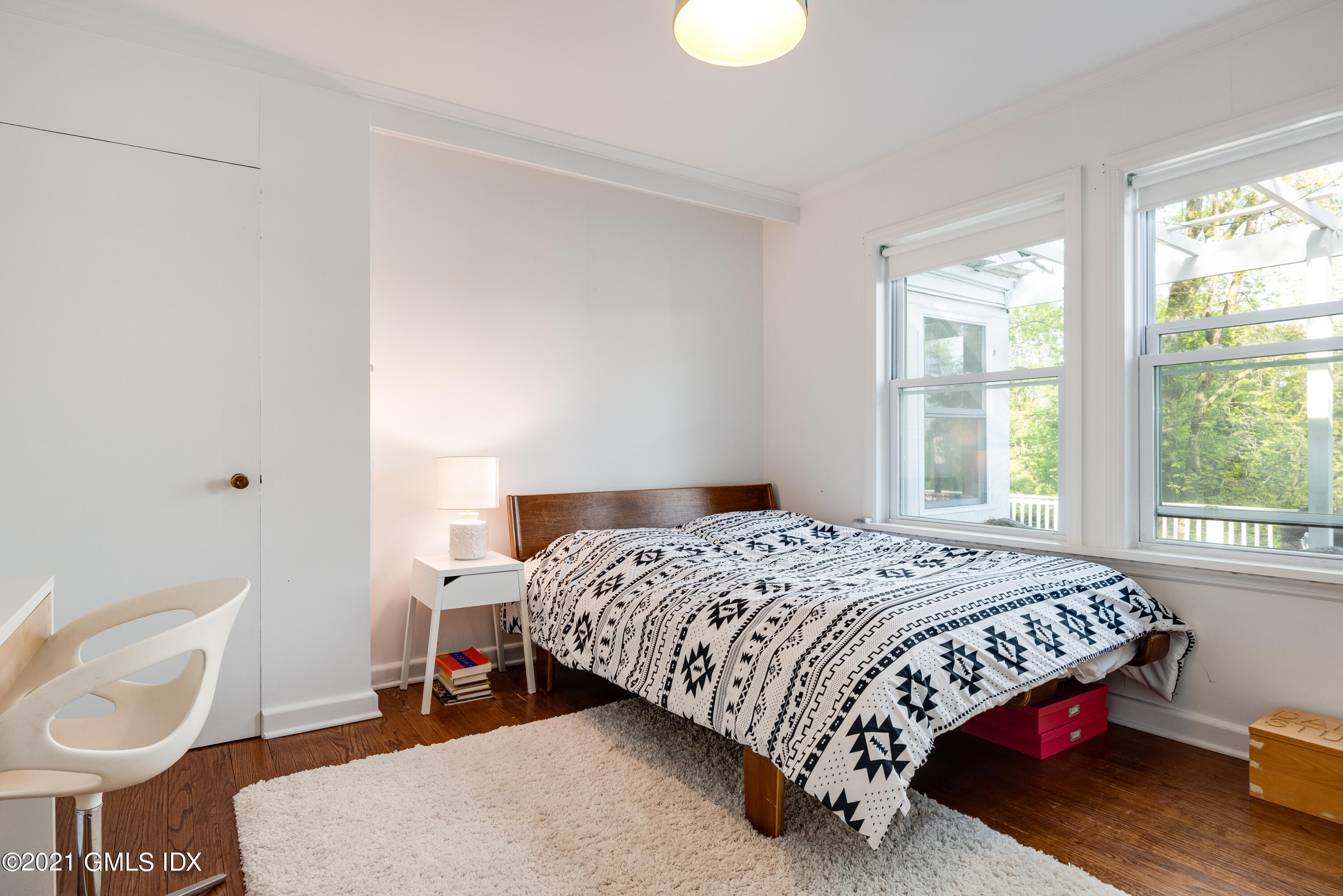 90 Oneida Drive Greenwich, CT 06830 - Photo 23 of 30 a bedroom with a bed a chair and a window