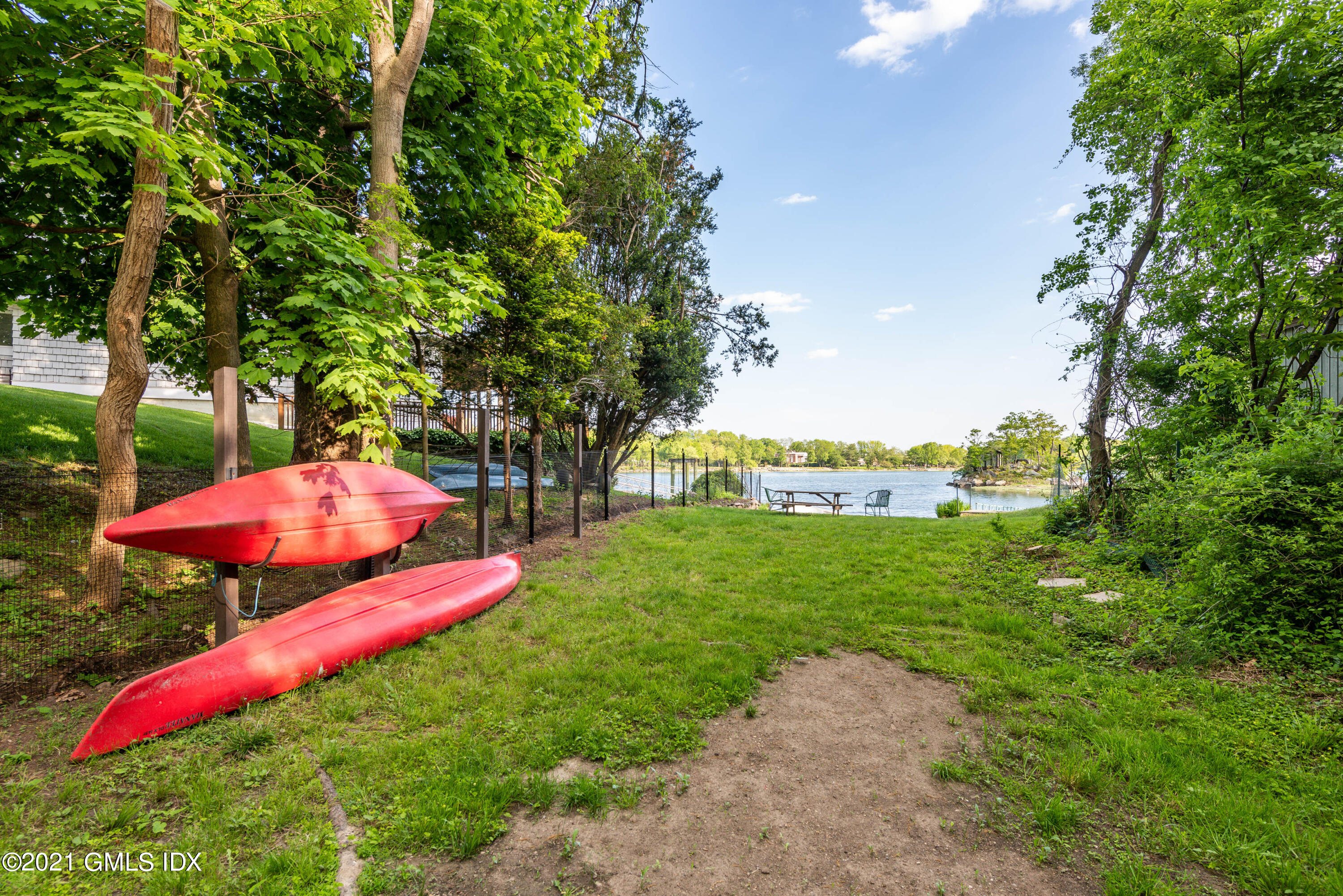 90 Oneida Drive Greenwich, CT 06830 - Photo 24 of 30 a backyard of a house with lots of green space and fountain