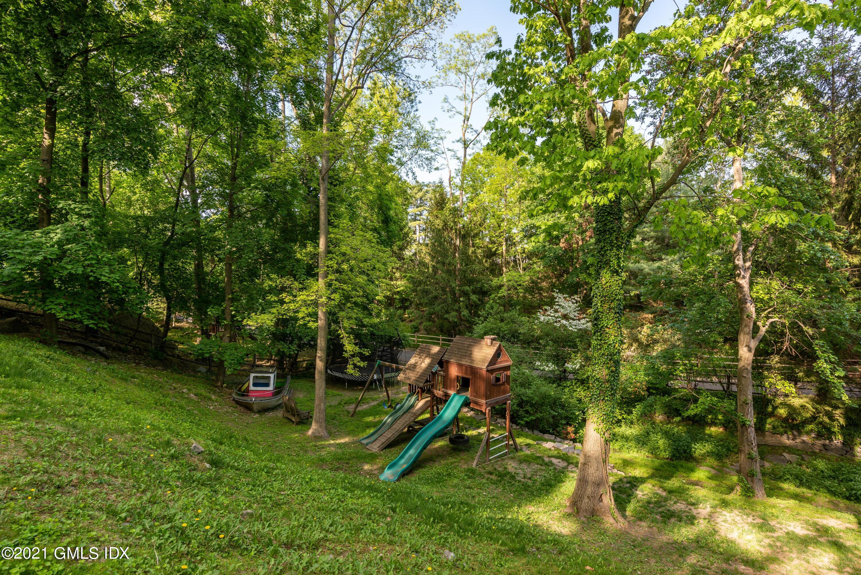 90 Oneida Drive Greenwich, CT 06830 - Photo 26 of 30 a view of a park with plants and a bench
