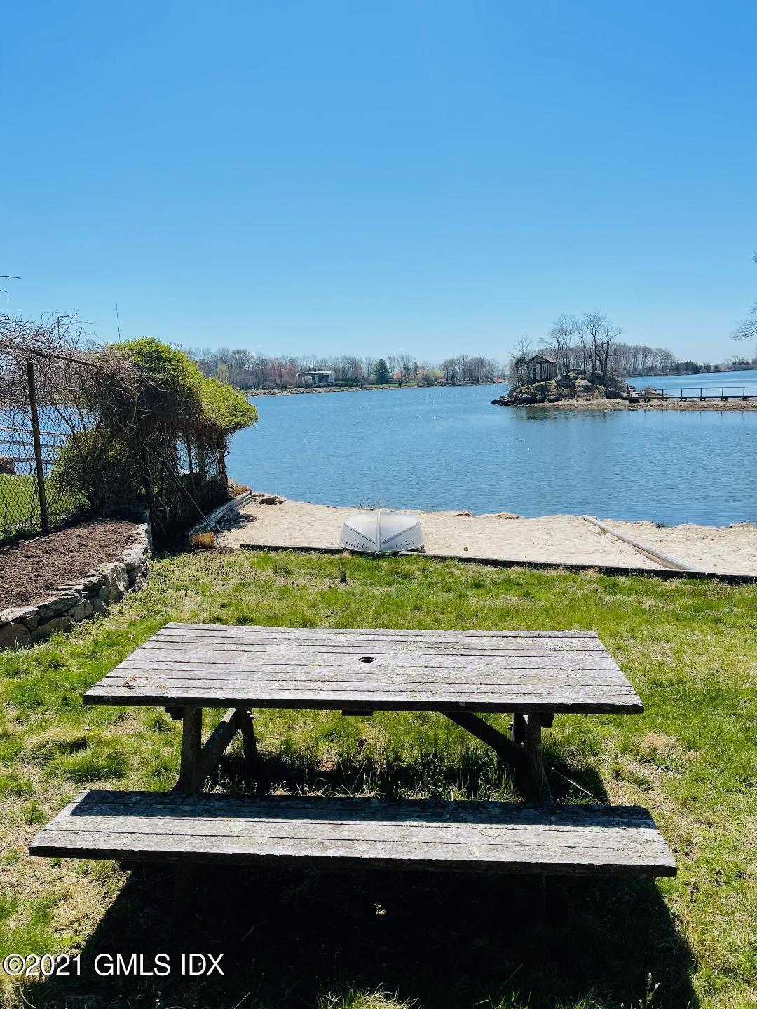 90 Oneida Drive Greenwich, CT 06830 - Photo 29 of 30 a view of a lake with a beach