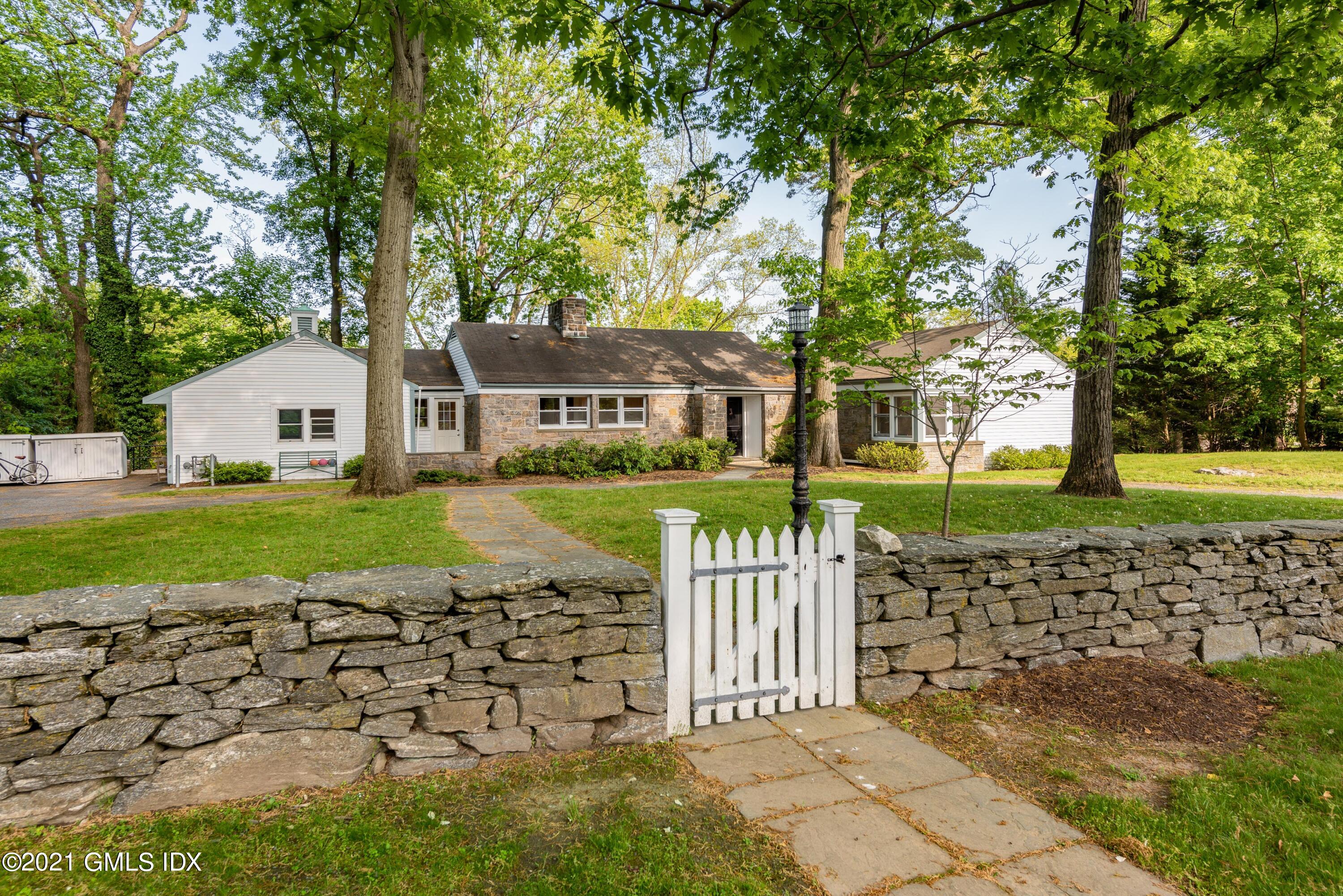 90 Oneida Drive Greenwich, CT 06830 - Photo 4 of 30 a front view of a house with a yard