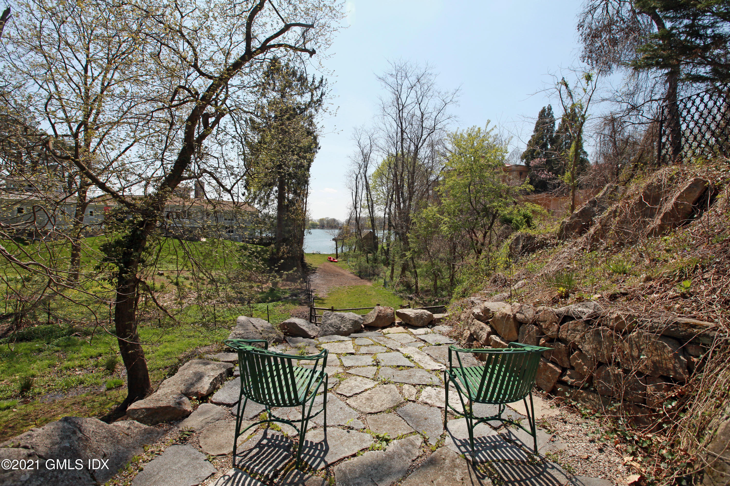 90 Oneida Drive Greenwich, CT 06830 - Photo 6 of 30 a view of a patio with table and chairs and potted plants