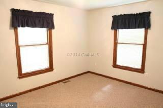 6536 Libertytown Road Berlin, MD 21811 - Photo 8 of 11 a white house that has a sliding door and a door