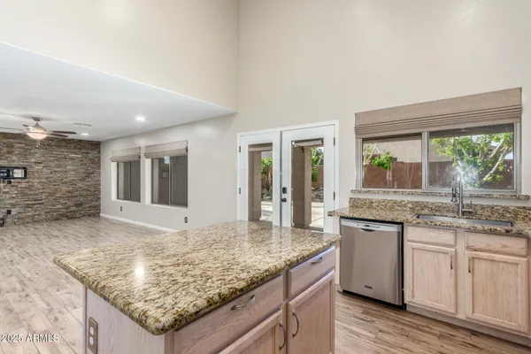 a kitchen with granite countertop sink and stove