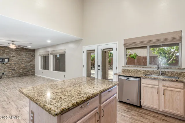 a kitchen with granite countertop sink and stove