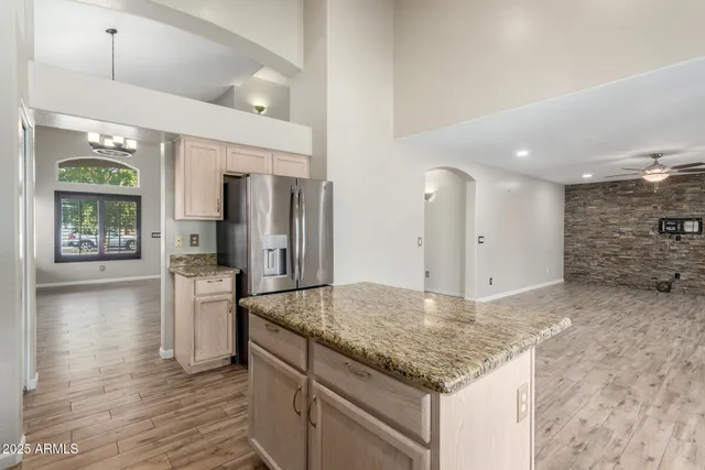 a kitchen with stainless steel appliances granite countertop a refrigerator and a sink