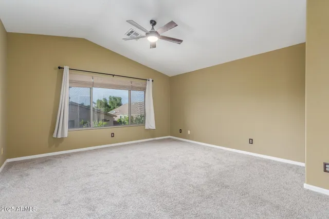 a view of room with window and ceiling fan