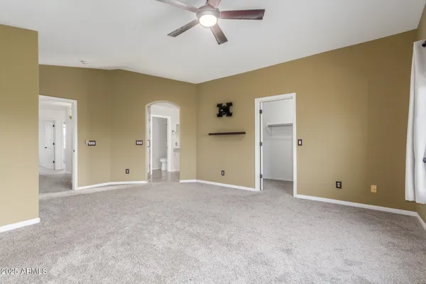 a view of empty room with ceiling fan