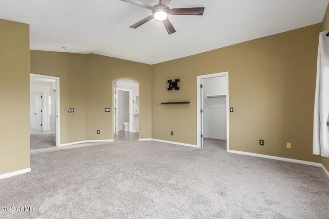 a view of empty room with ceiling fan