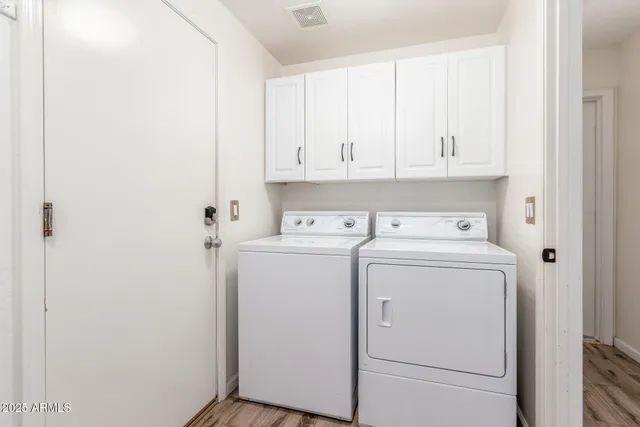 a view of storage and utility room with washer and dryer