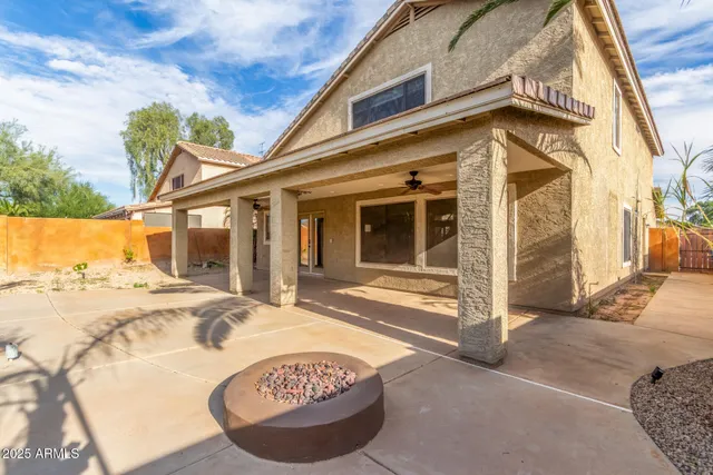 a view of a house with a wooden bench