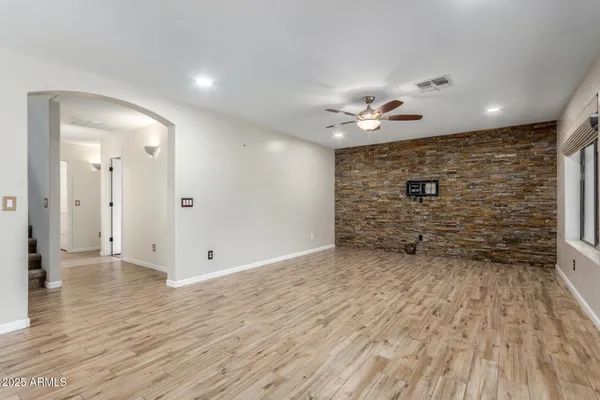 wooden floor in an empty room with a bathroom
