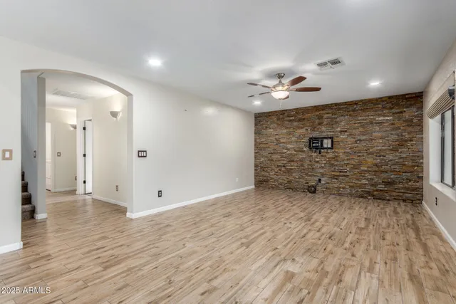 wooden floor in an empty room with a bathroom