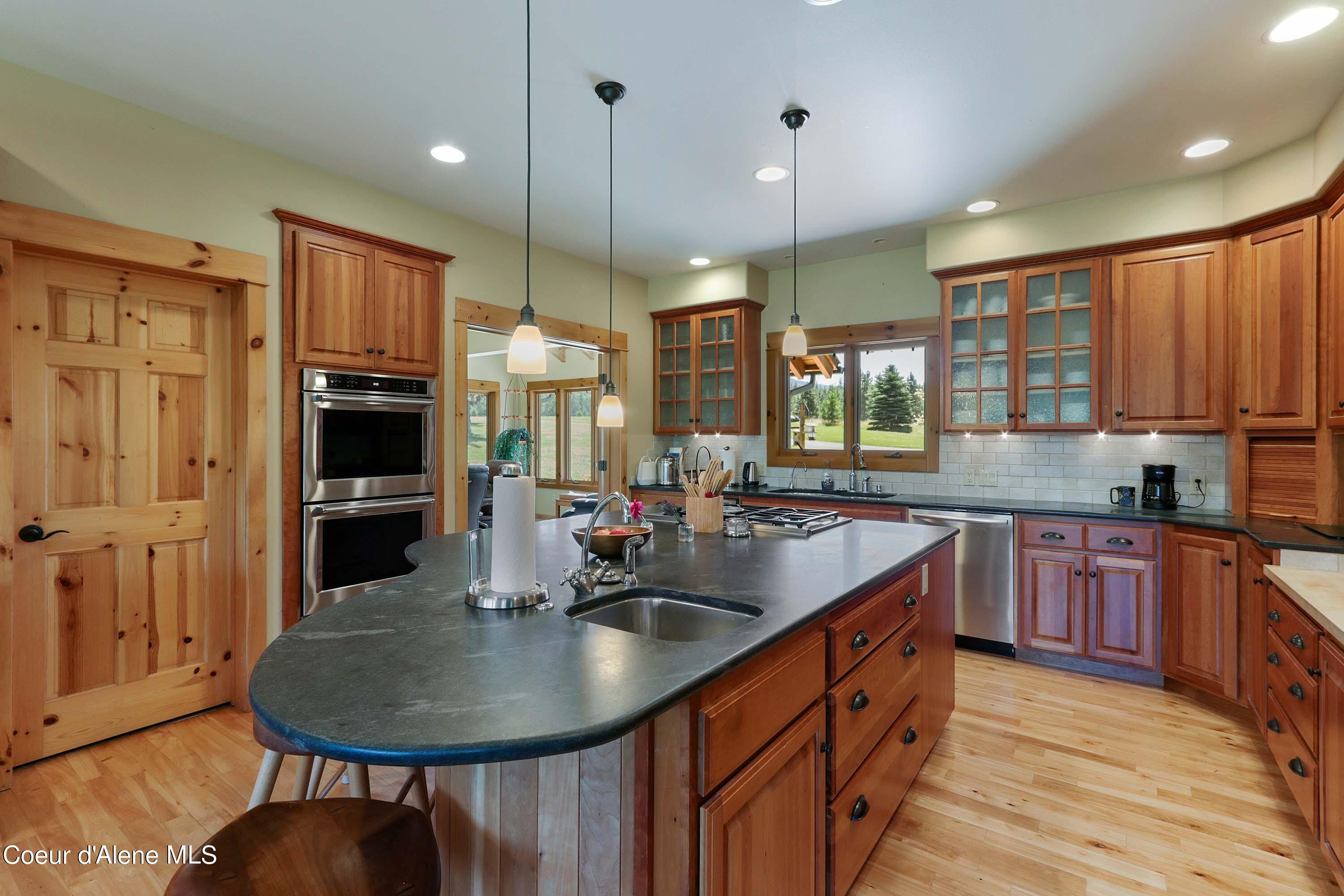 877 Heath Lake Road Sagle, ID 83860 - Photo 11 of 60 Kitchen to Sunroom