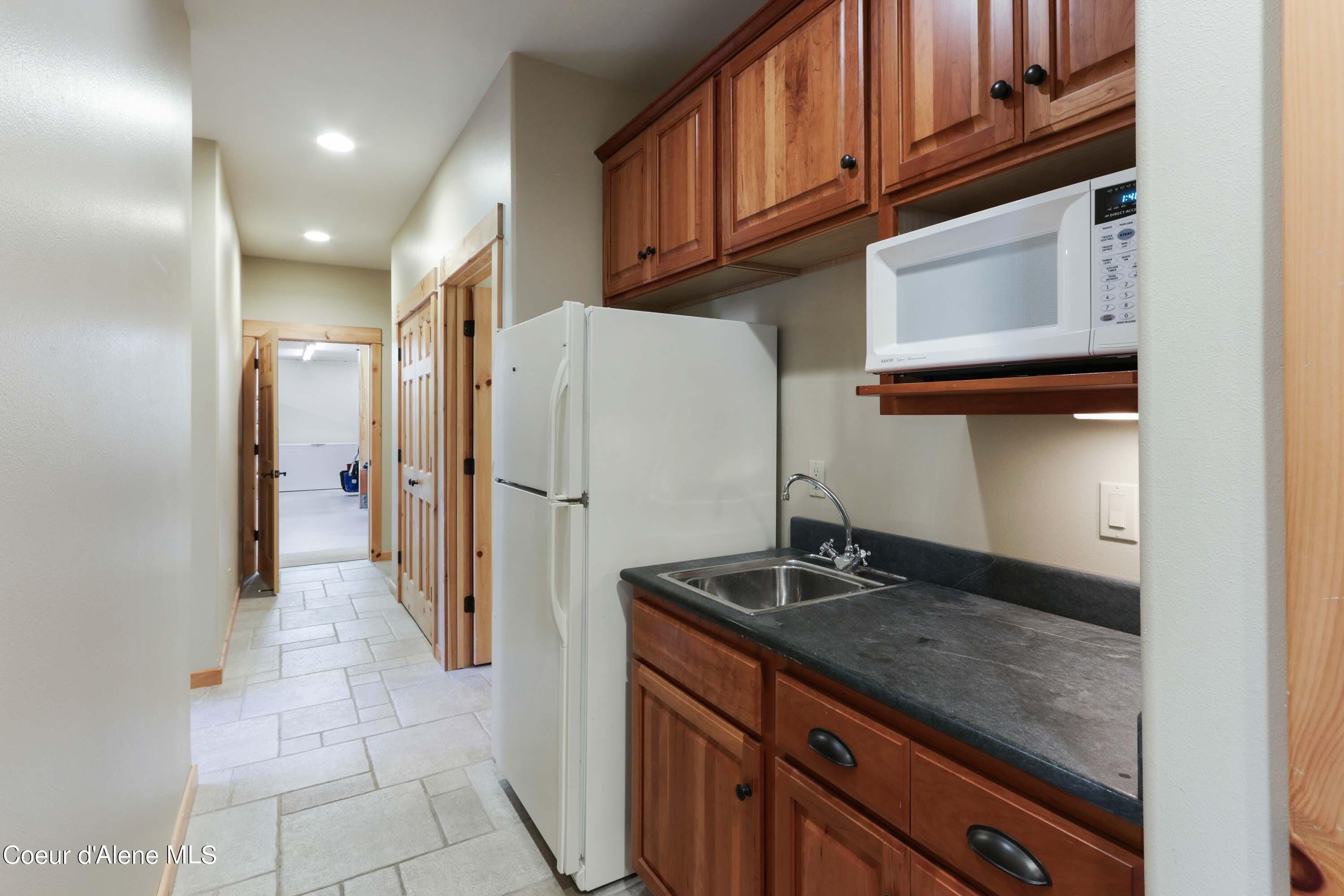 877 Heath Lake Road Sagle, ID 83860 - Photo 35 of 60 Downstairs Kitchen Area to Large Storage