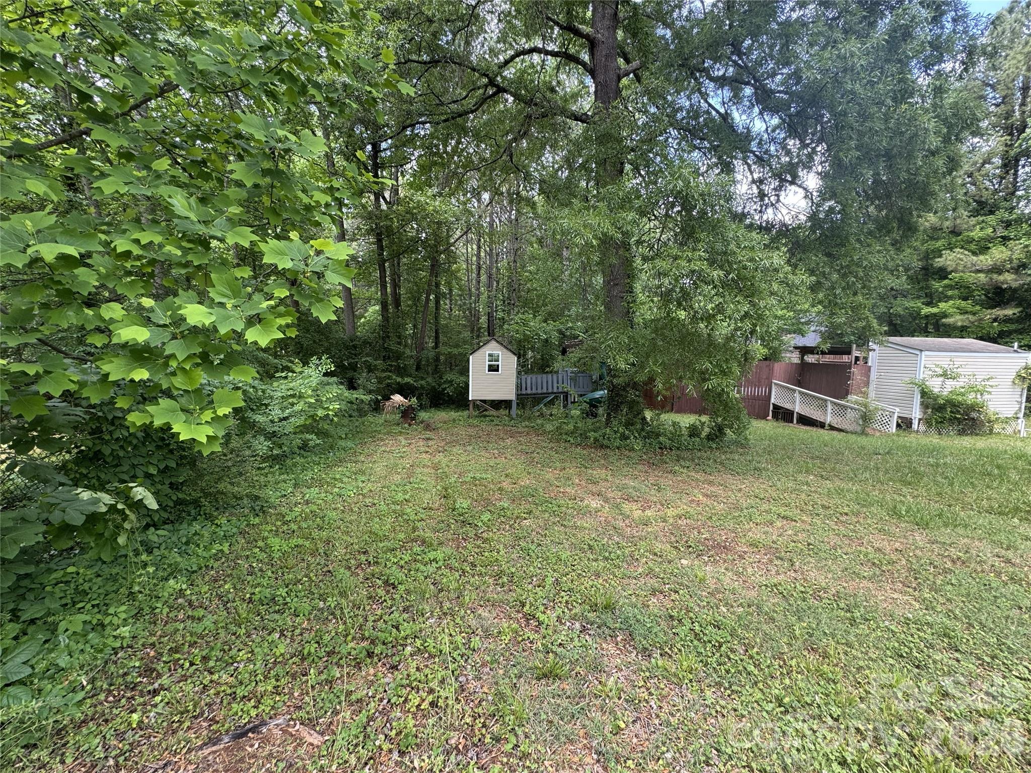 8441 Shelley Mullis Road Fort Mill, SC 29707 - Photo 19 of 23 a view of a outdoor space with deck and yard
