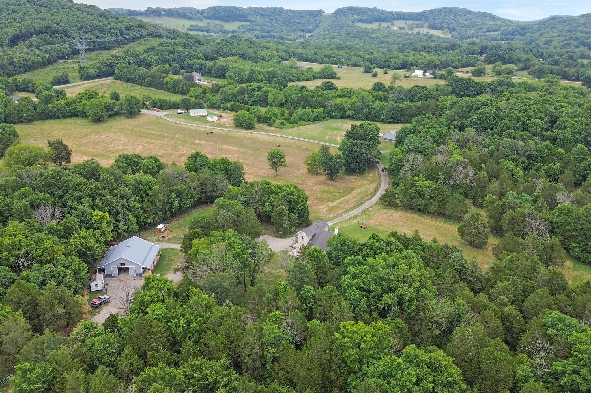 6770 Bly-Trice Road College Grove, TN 37046 - Photo 47 of 58 an aerial view of green landscape with trees houses and mountain view