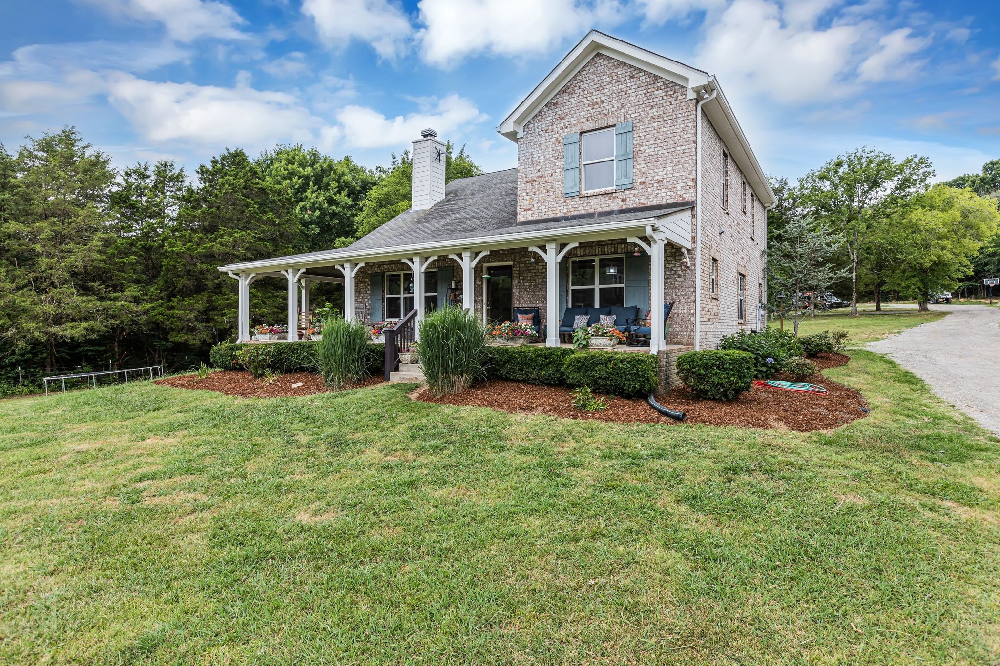 6770 Bly-Trice Road College Grove, TN 37046 - Photo 57 of 58 a front view of a house with a yard and potted plants