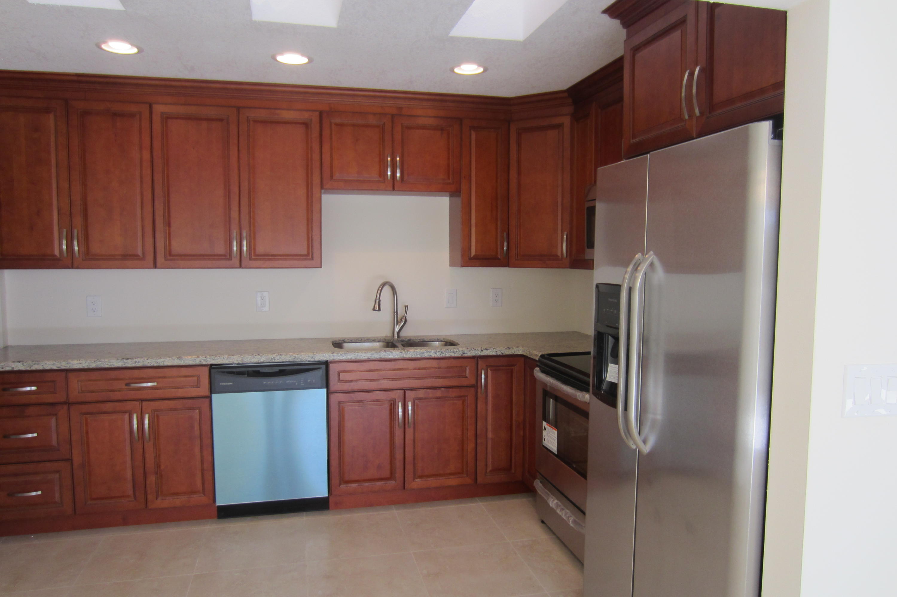 310 Northeast 23rd Way Boca Raton, FL 33431 - Photo 3 of 16 a kitchen with stainless steel appliances granite countertop a refrigerator and a sink