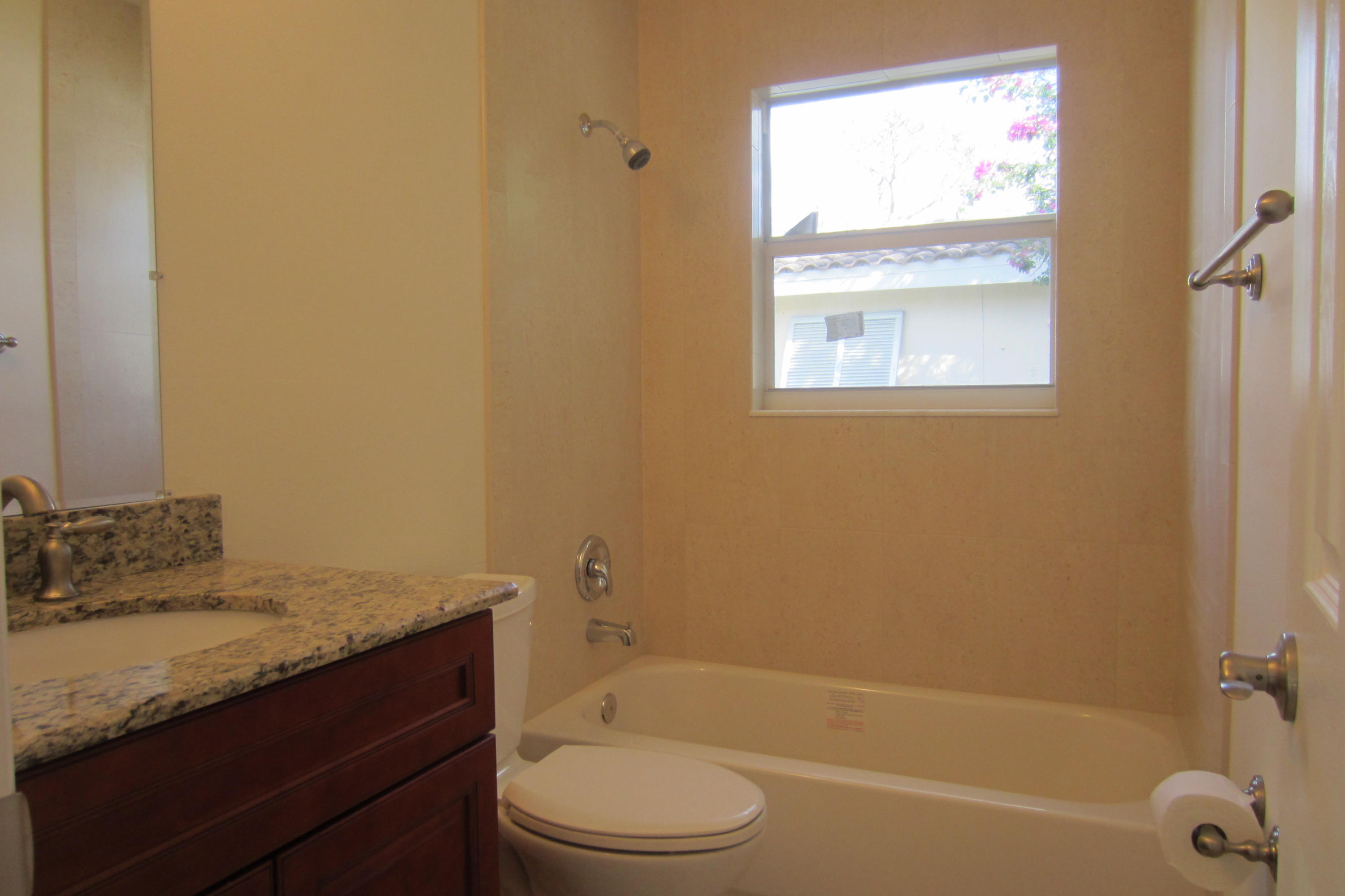 310 Northeast 23rd Way Boca Raton, FL 33431 - Photo 4 of 16 a bathroom with a granite countertop sink toilet and shower