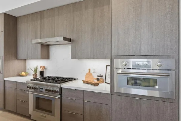 a kitchen with a stove and a white cabinets