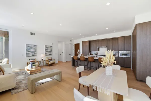 a dining room with furniture and wooden floor