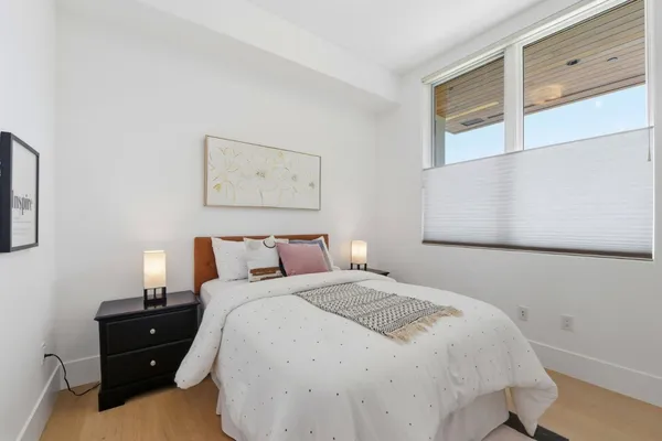 a bedroom with a bed and a window