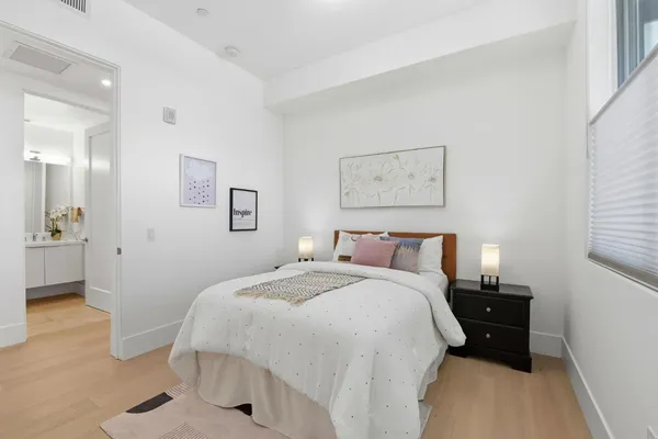 a bedroom with a bed and a window