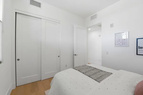 a bedroom with a bed and a lamp