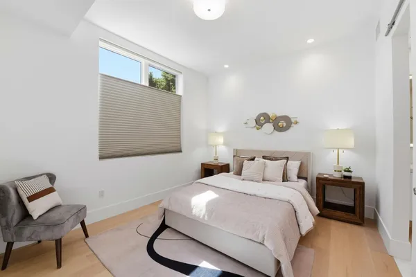 a bedroom with a bed and a chair