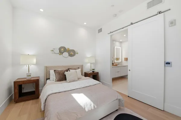 a bedroom with a bed and a chair