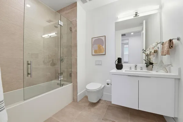 a en suite bathroom with a double vanity sink and a mirror