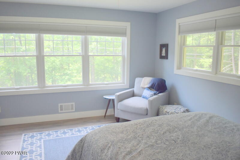 549 Finn Swamp Road Lakeville, PA 18438 - Photo 13 of 35 a bedroom with two beds and a large window