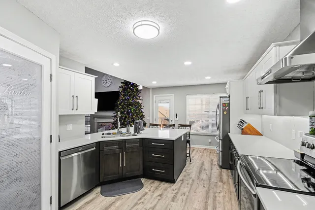 a kitchen with a sink stove and cabinets
