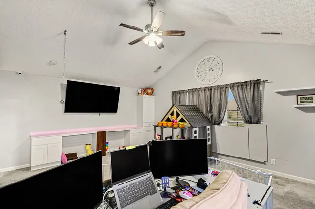 a room with furniture a flat screen tv and a window