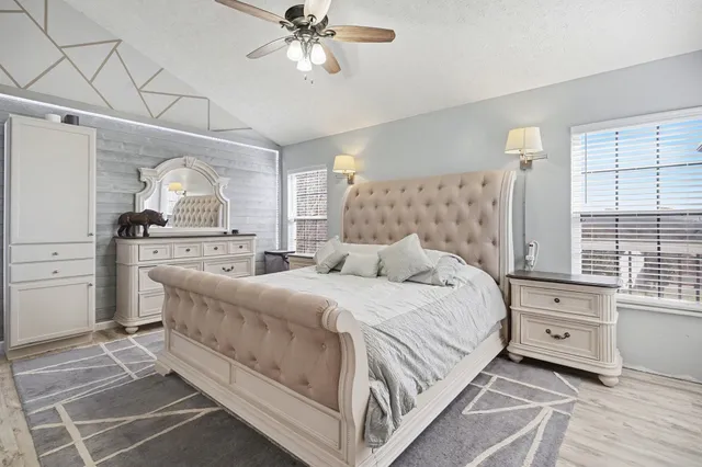 a bedroom with a large bed and a window