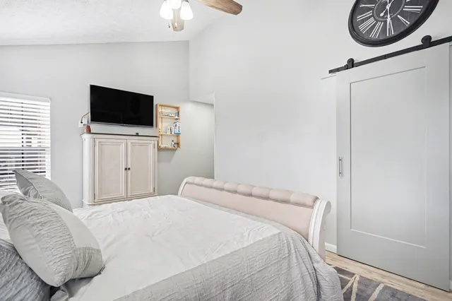 a bedroom with a bed and a television