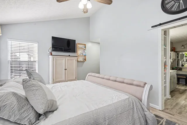a bedroom with a bed and a flat screen tv