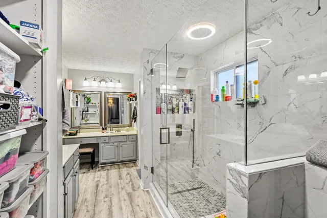a bathroom with a sink a mirror and shower
