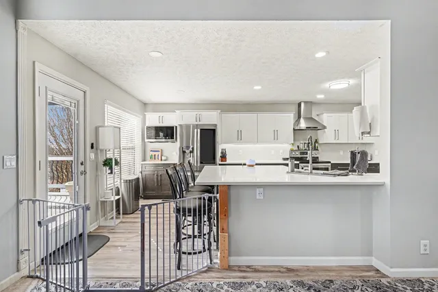 a kitchen with stainless steel appliances kitchen island granite countertop a sink and cabinets
