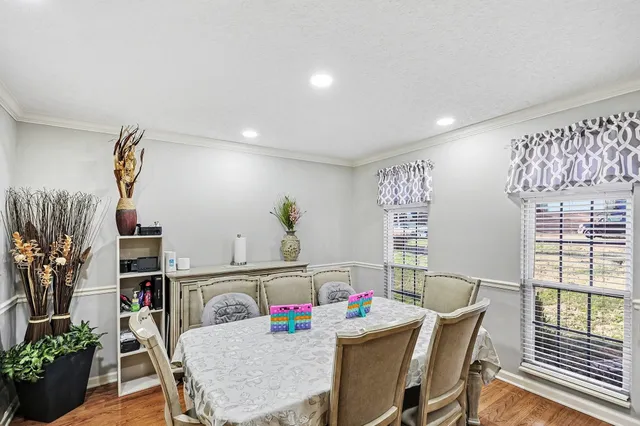 a view of a dining room with furniture and a potted plant