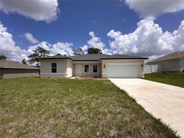 a view of a house with a back yard